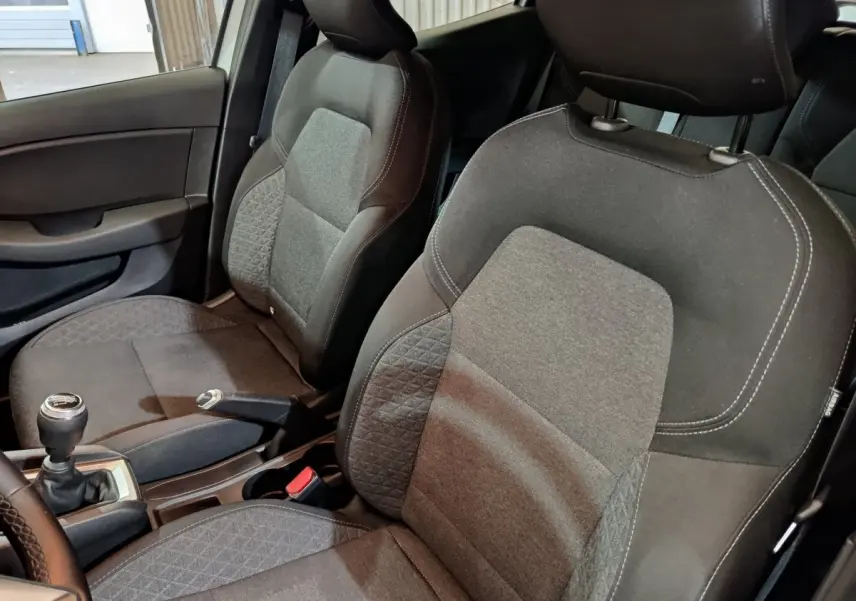 Vue intérieure rapprochée des sièges avant en tissu gris et noir de la Renault Clio Business TCe 90 2021.