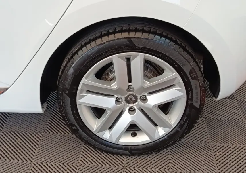 Gros plan sur la roue arrière droite d'une Renault Clio Business Blue dCi 100 blanche, avec passage de roue et partie de la carrosserie visibles.