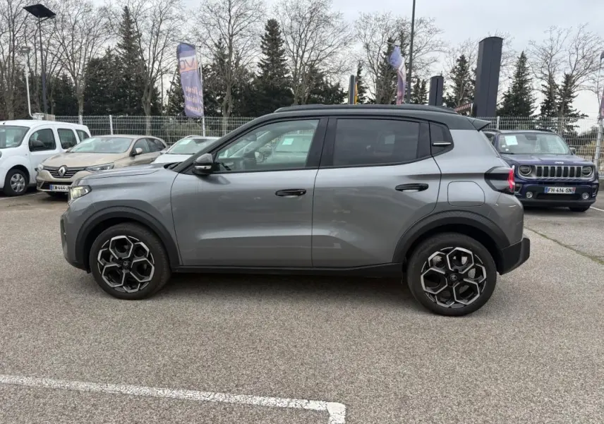 Profil côté gauche d'une Citroën C3 gris 2025 avec jantes alliage 17 pouces et barres de toit noires.