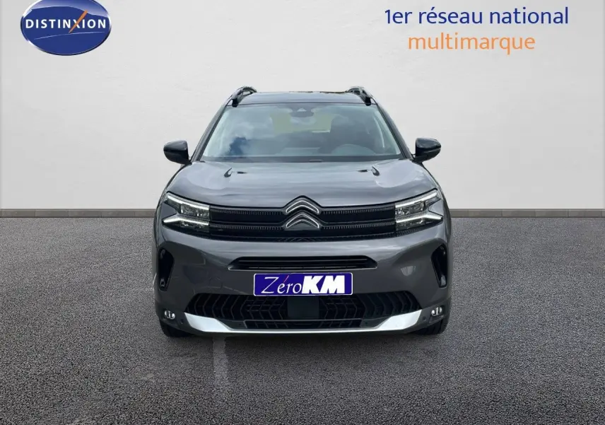 Citroën C5 Aircross gris platinium métal vue de face avec toit noir et calandre distinctive en ville.