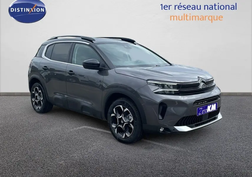 Citroën C5 Aircross gris platinium métal avec toit noir, vue 3/4 avant mettant en valeur ses jantes biton et calandre moderne.