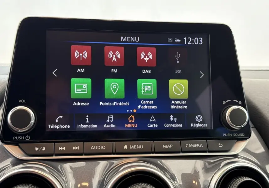 Écran tactile central du tableau de bord du Nissan Juke gris foncé 2023 affichant le menu de navigation.