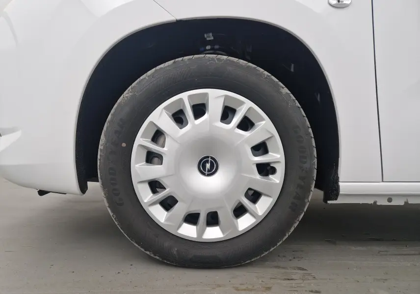 Gros plan sur la roue avant gauche blanche d'un Opel Combo Life M 1.5 BlueHDi avec jante et logo Opel visibles.