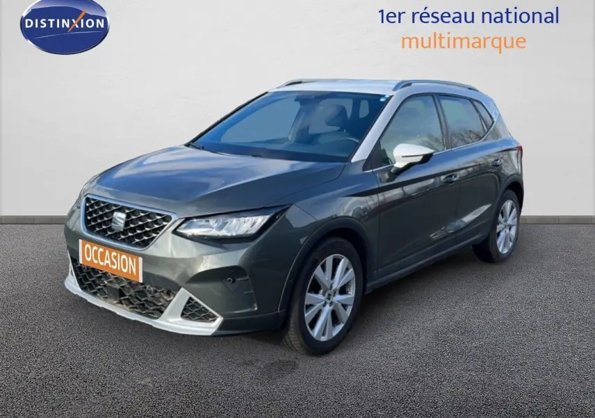 SEAT Arona gris magnétique en vue 3/4 avant droit, avec jantes alliage et rétroviseurs blancs contrastants.