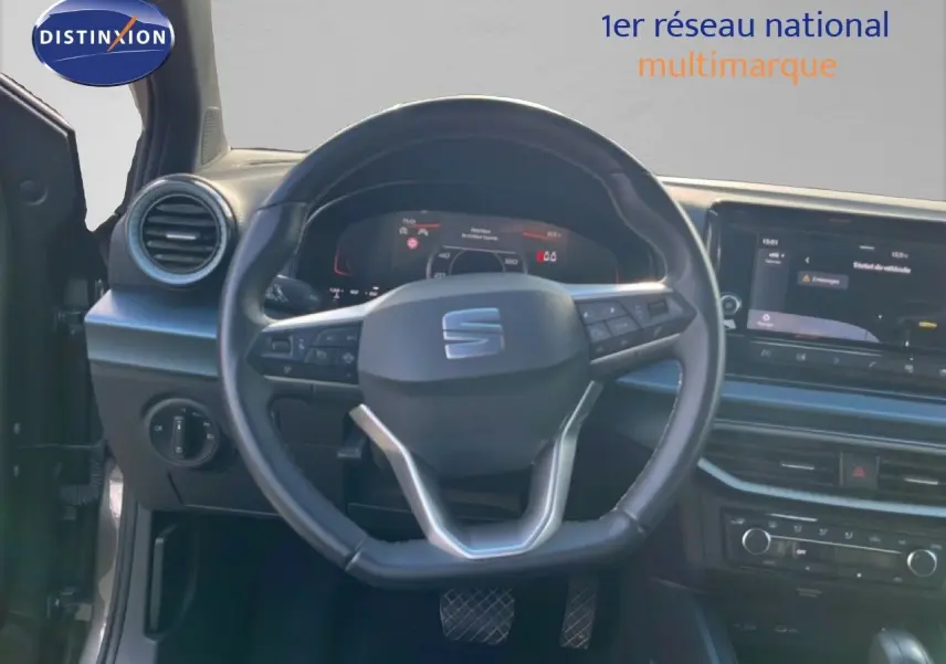 Vue intérieure frontale du volant cuir noir du SEAT Arona 2025 avec tableau de bord digital et écran tactile central.