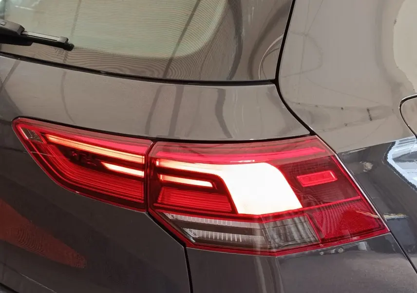 Feu arrière droit allumé sur Volkswagen Golf gris foncé 2022, avec logo Golf visible sur le feu.