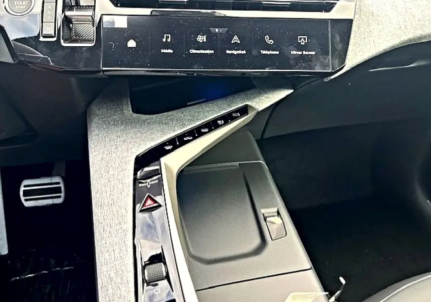 Vue rapprochée de la console centrale grise et noire du Peugeot 3008 1.2 hybrid 136 GT avec écran tactile et commandes intégrées.
