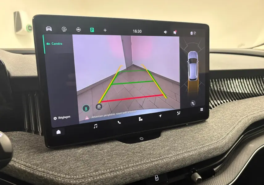 Écran tactile intérieur montrant la caméra de recul avec guidage, tableau de bord gris tissu du Skoda Superb Combi 2025.