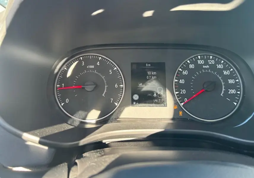 Vue rapprochée du tableau de bord numérique et compteurs analogiques de la Dacia Sandero III Stepway noir nacré.