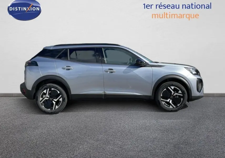 Vue de profil côté gauche d'un Peugeot 2008 gris avec jantes aluminium et barres de toit noires.