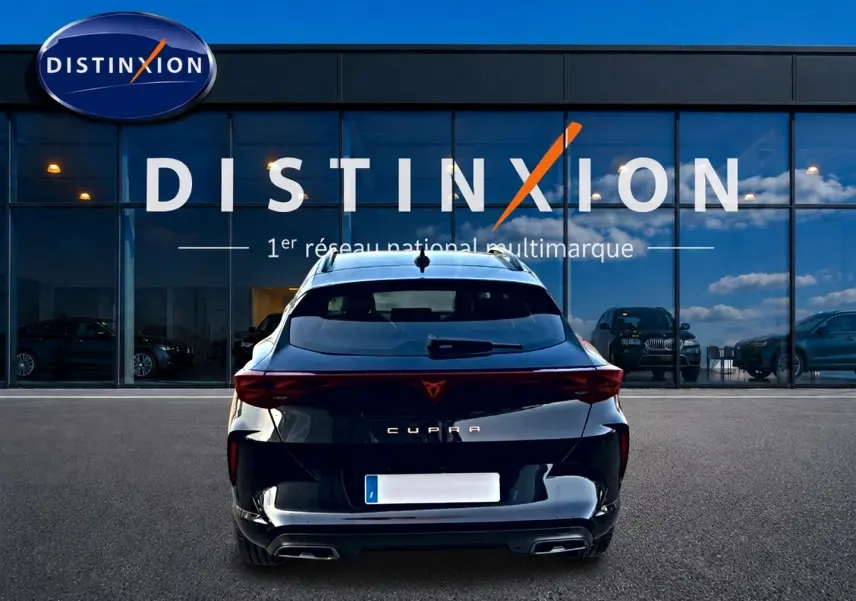 Vue arrière d'un CUPRA Formentor noir 2026 avec feux LED et double sortie d'échappement, devant une vitrine Distinxion.