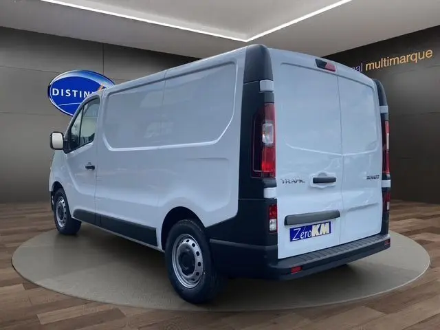 Vue 3/4 arrière droite d'un Renault Trafic Fourgon blanc 2025 avec portes arrière battantes et jantes acier noires.
