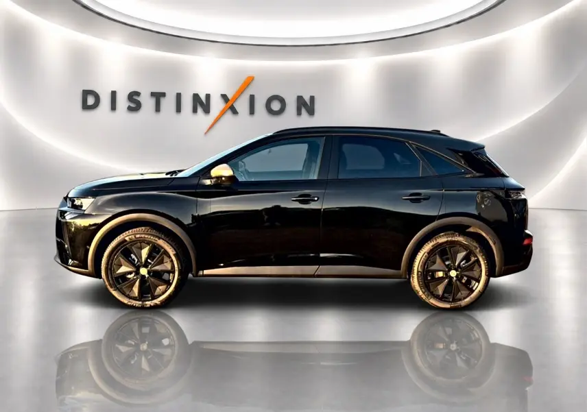 Vue de profil côté gauche d’un DS7 noir 2026 avec jantes noires et rétroviseurs dorés dans un showroom lumineux.