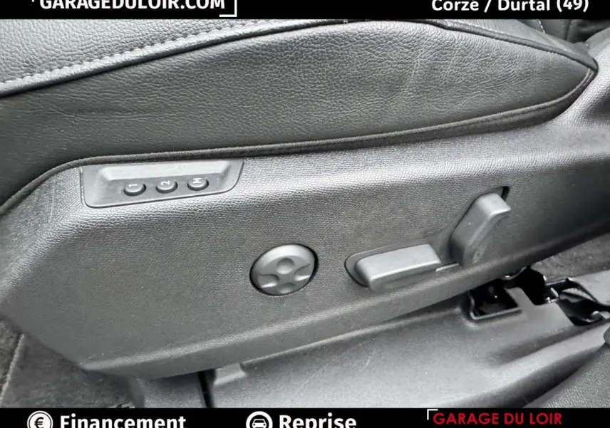 Détail des commandes électriques de réglage de siège en cuir noir dans un DS7 Crossback Bleu 2024.