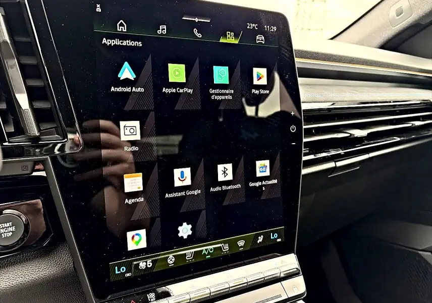 Écran tactile central en gros plan à l'intérieur du Renault Austral gris schiste, affichant les applications connectées.