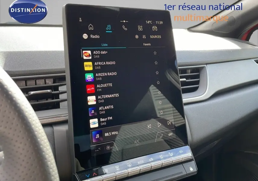 Vue intérieure du tableau de bord du Renault Captur E-Tech hybride 2025, écran tactile central affichant les radios numériques.