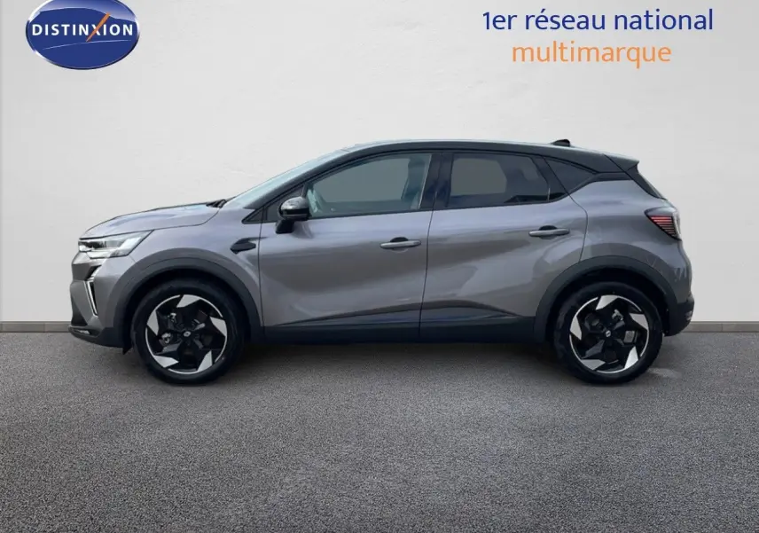 Profil côté gauche du Renault Captur E-Tech hybride 2025 gris cassiopée avec toit noir et jantes bi-ton.