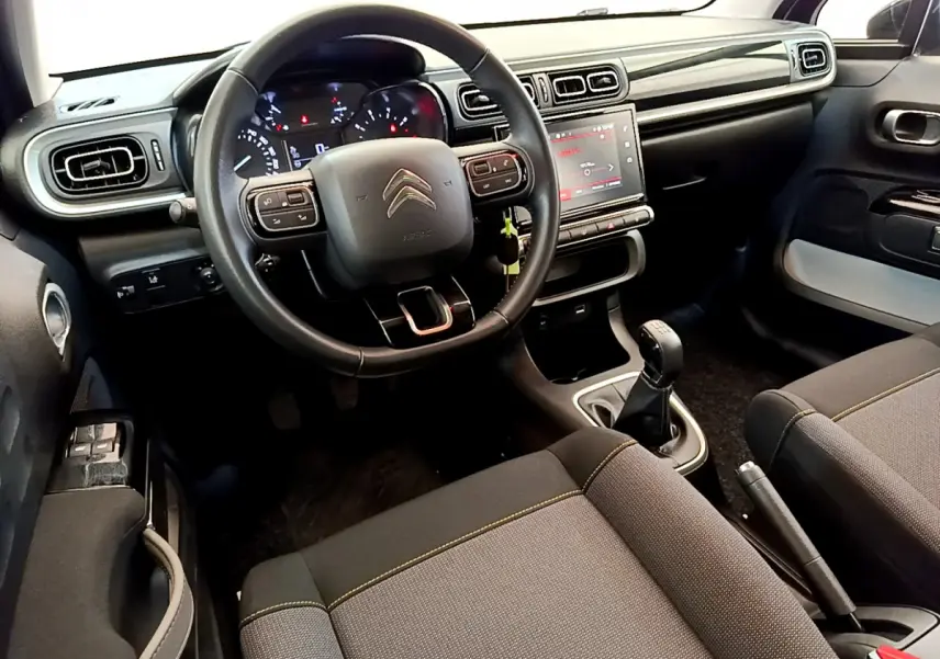 Intérieur de la Citroën C3 2019, vue du poste de conduite avec volant cuir et écran tactile central.