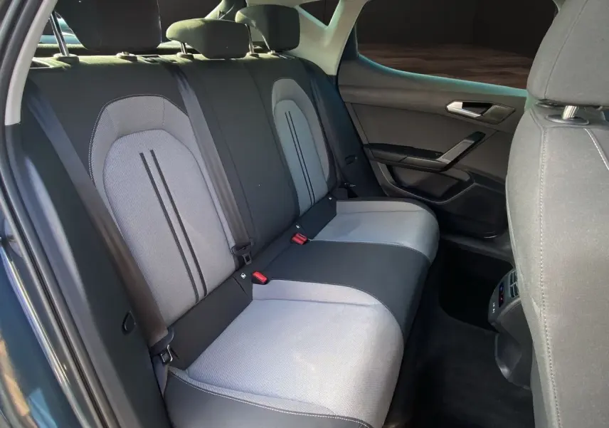 Vue intérieure sur les sièges arrière en tissu noir et gris clair d'une SEAT LEON IV 2024, côté droit ouvert.