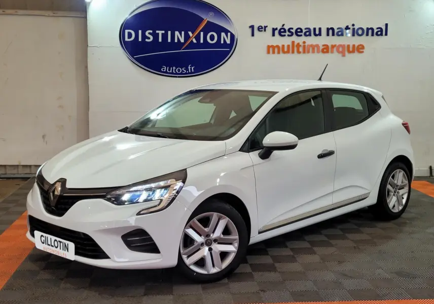 Renault Clio Business blanche vue 3/4 avant droit avec phares LED allumés en intérieur showroom