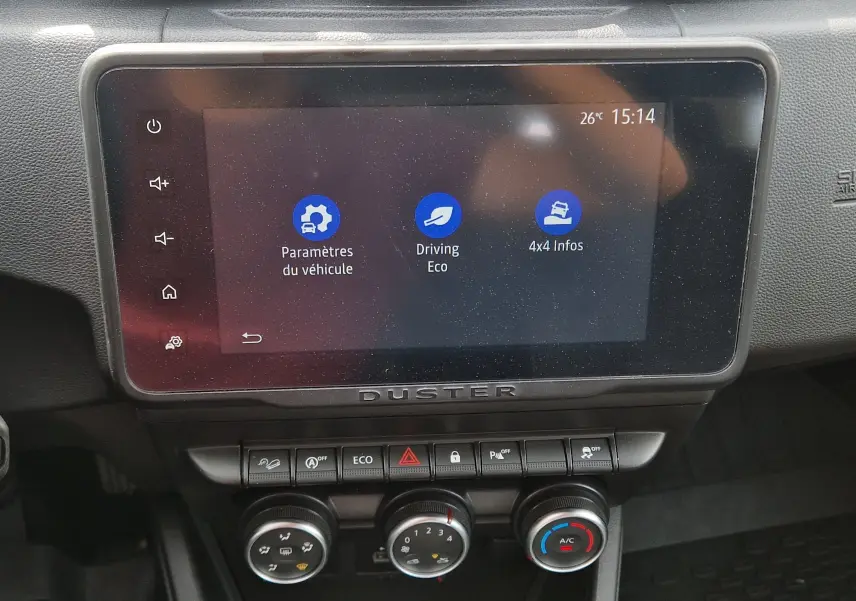 Écran tactile central du tableau de bord du Dacia Duster 2023 montrant les paramètres véhicule, mode éco et infos 4x4.