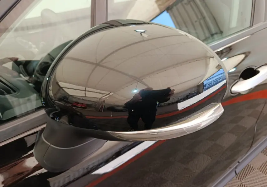 Rétroviseur extérieur droit noir brillant avec clignotant intégré sur FIAT 500X blanc, vue rapprochée.