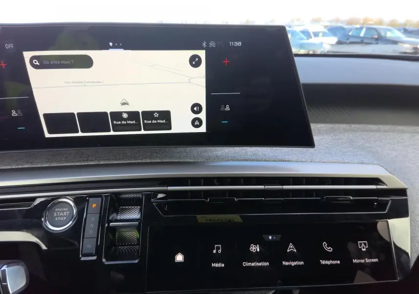 Vue intérieure du tableau de bord du Peugeot 3008 Hybrid 2025, avec écran tactile incurvé et commandes digitales.