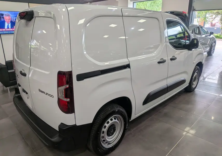 Vue 3/4 arrière droite d’un Citroën Berlingo blanc version VAN Diesel 2025 en showroom avec portes arrière fermées.