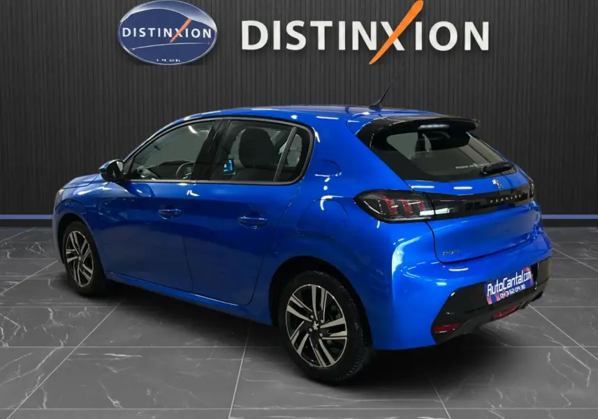 Peugeot 208 Bleu Vertigo vue 3/4 arrière côté gauche, avec jantes alliage et vitres teintées, en intérieur showroom.