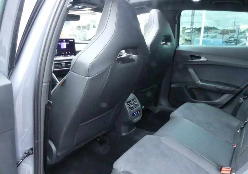 Vue arrière intérieure de la CUPRA Formentor 2025 gris Graphène, sièges bimatière noir et suédine, climatisation tri-zone visible.