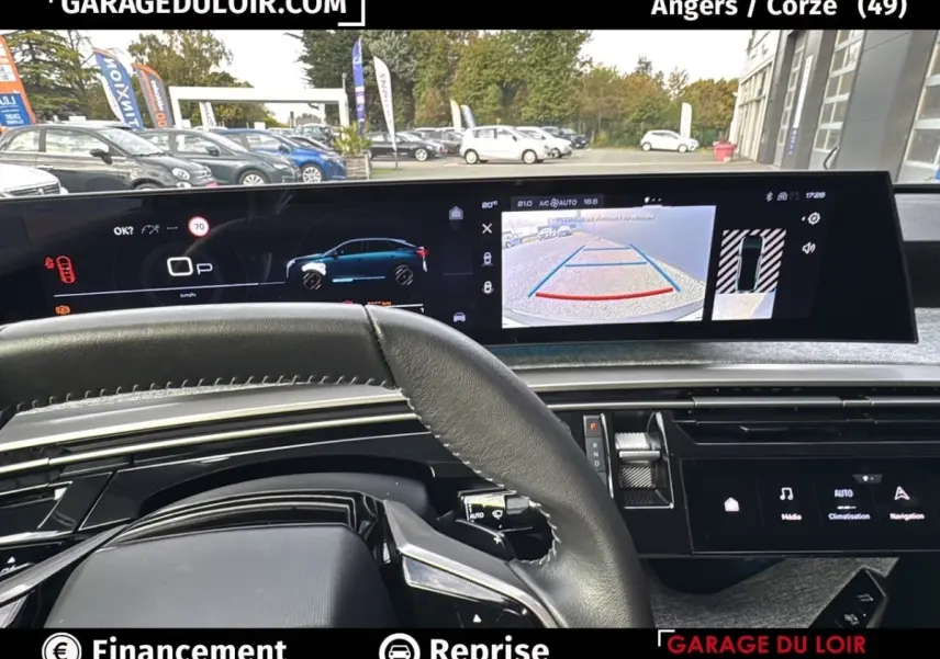Vue intérieure du tableau de bord du Peugeot 3008 1.2 Hybrid 136 Allure 2024, écran multifonction et caméra de recul visibles.