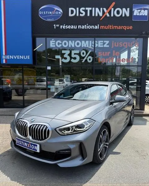 BMW Série 1 118d Edition Sport gris foncé vue 3/4 avant avec calandre imposante et phares LED distinctifs.