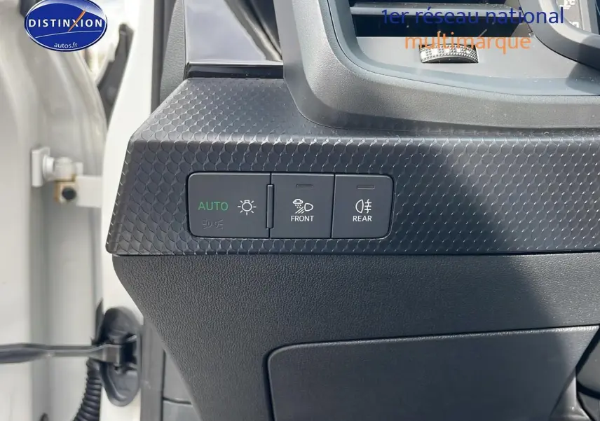 Vue rapprochée du tableau de bord côté gauche d'une Audi A1 Sportback blanche, avec commandes d'éclairage et texture noire.