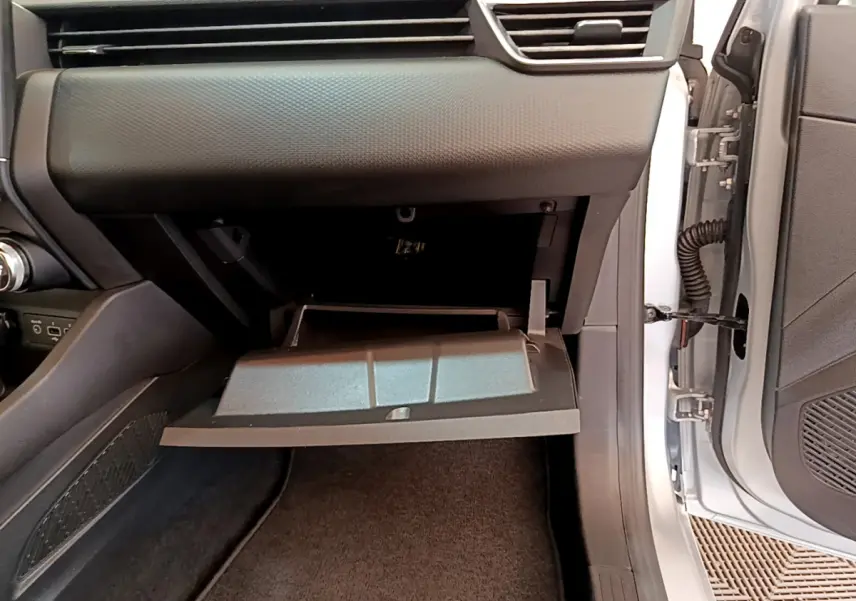 Vue intérieure côté passager de la Renault Clio Business E-Tech 2021, boîte à gants ouverte, tableau de bord gris clair.