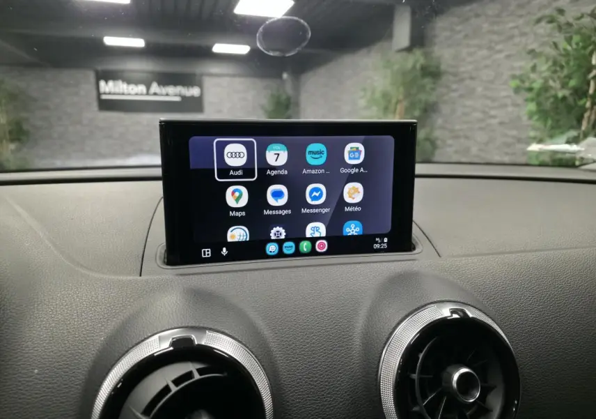Écran tactile central affichant des applications, sur le tableau de bord gris d'une Audi A3 Sportback 2017.