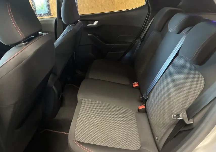 Vue intérieure arrière de la Ford Fiesta 1.0 EcoBoost 95 ST Line 2020, sièges tissu gris noir avec surpiqûres rouges.