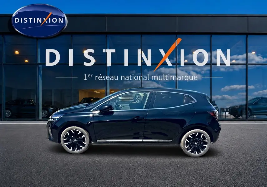 Profil côté gauche de la Renault Clio V noire 2025 avec jantes alu noires, devant une vitrine Distinxion.