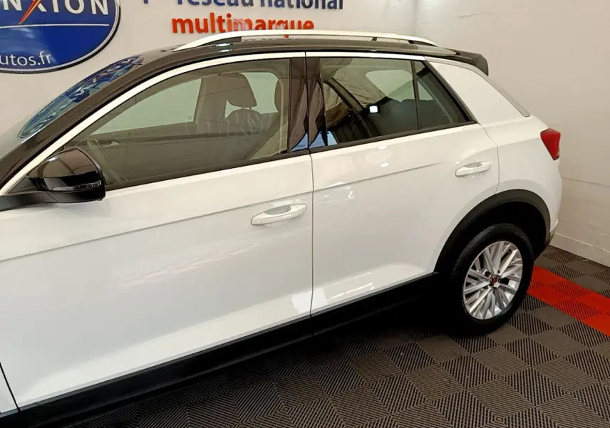 Profil côté gauche blanc du Volkswagen T-Roc 2021 avec rétroviseurs noirs et jantes alliage multibranches