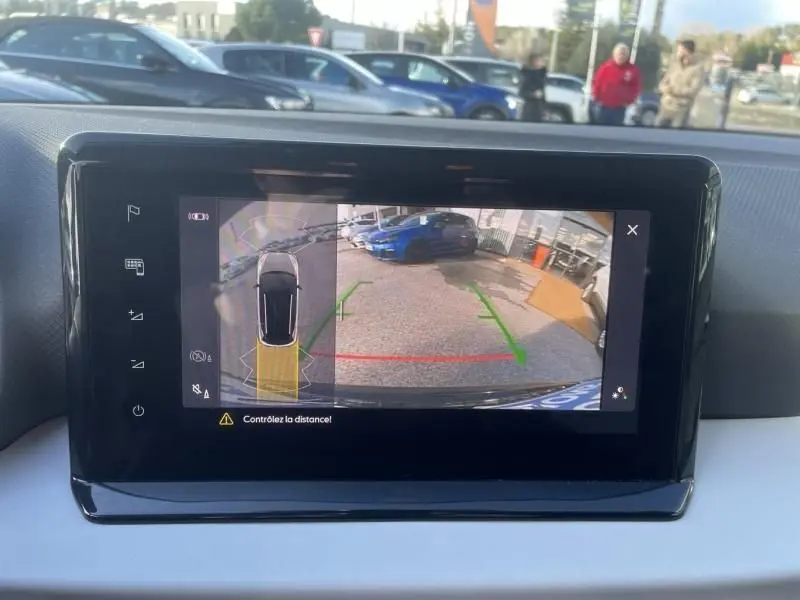 Écran intérieur montrant la caméra de recul d’un SEAT Arona noir 2023 avec guidage de trajectoire en vert et rouge.