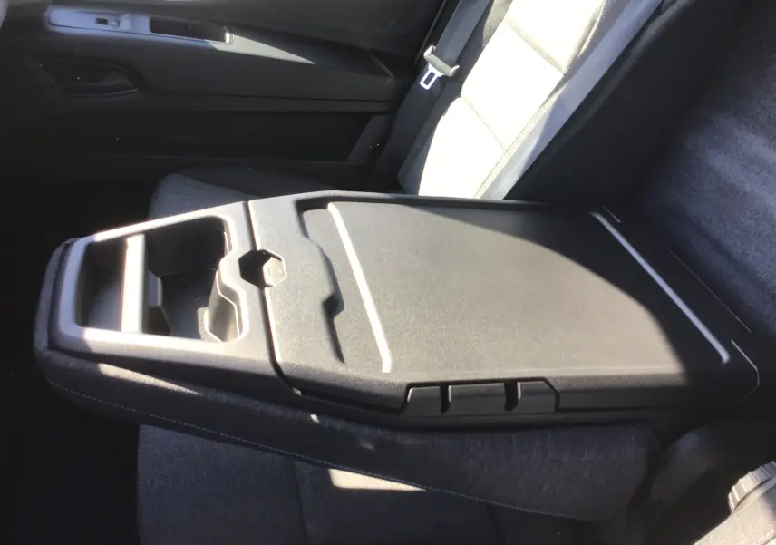 Gros plan sur la banquette passager grise du Renault Master 2025 avec bureau mobile intégré et rangement.