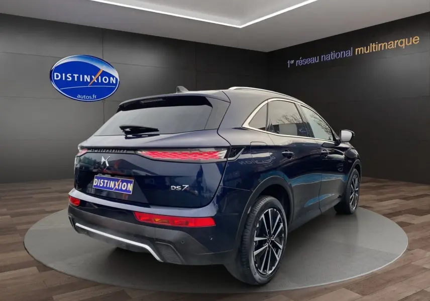 Vue 3/4 arrière droite du DS7 Bleu Éclipse avec feux arrière allongés et jantes alliage bicolores.