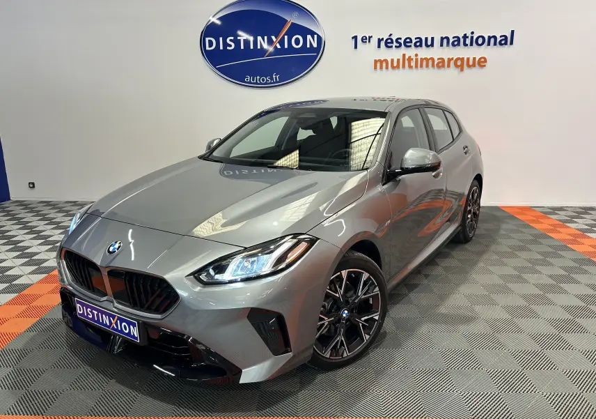BMW Série 1 120DA M Sport gris Skyscrap vue 3/4 avant droit avec phares LED allumés en intérieur showroom
