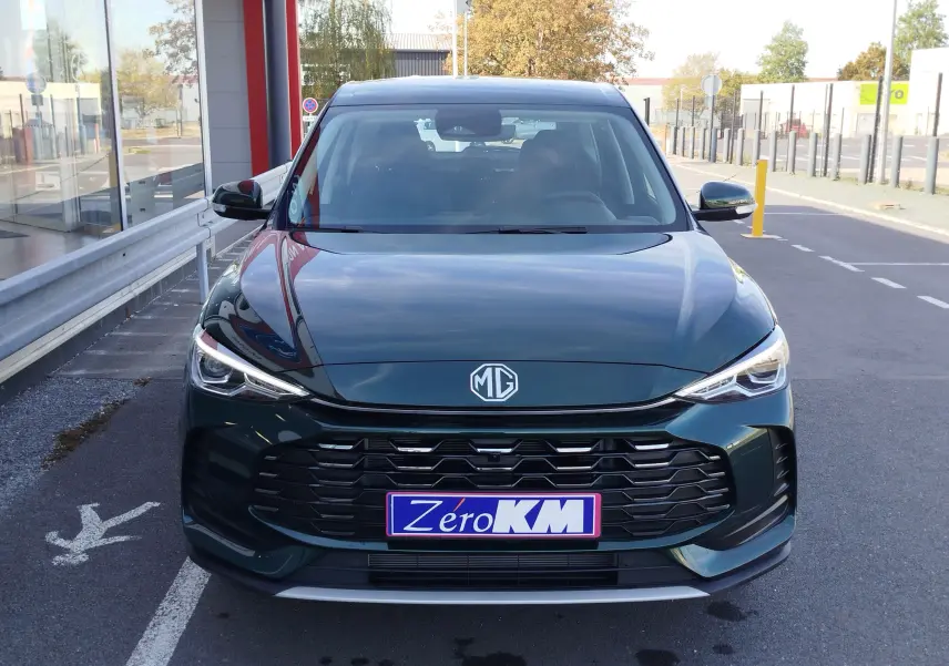 Vue frontale du MG ZS 1.5L Hybrid+ 197CH en vert émeraude métallisé, avec calandre noire et phares LED fins.
