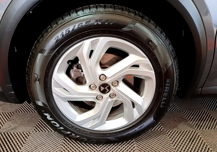 Gros plan sur la roue avant droite du DS7 Crossback gris foncé avec jante alliage et pneu Pirelli Scorpion.