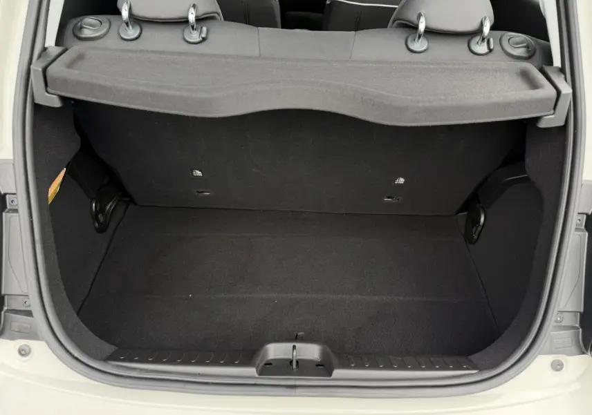 Coffre ouvert vu de l'arrière d'une FIAT 500 électrique blanc Artic, montrant l'espace de chargement et la plage arrière.