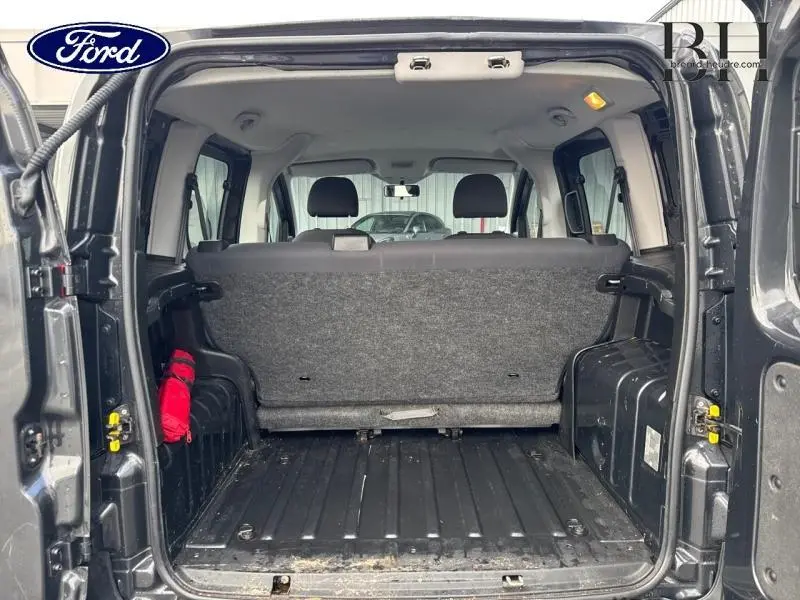 Vue arrière ouverte du coffre du Citroën Nemo gris Graphito montrant la banquette arrière et l'espace de chargement.