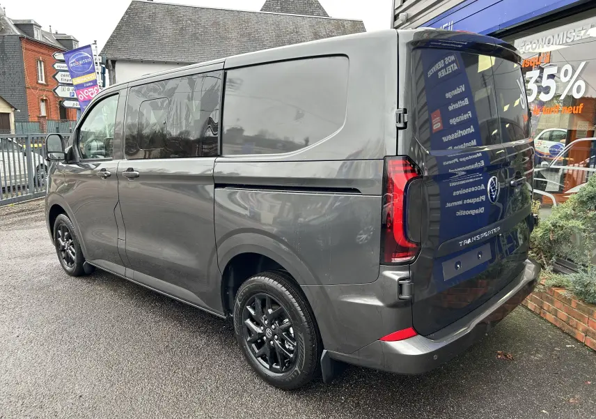 Vue 3/4 arrière droite du Volkswagen Transporter T7 ProCab graphite avec jantes noires brillantes et vitres teintées.