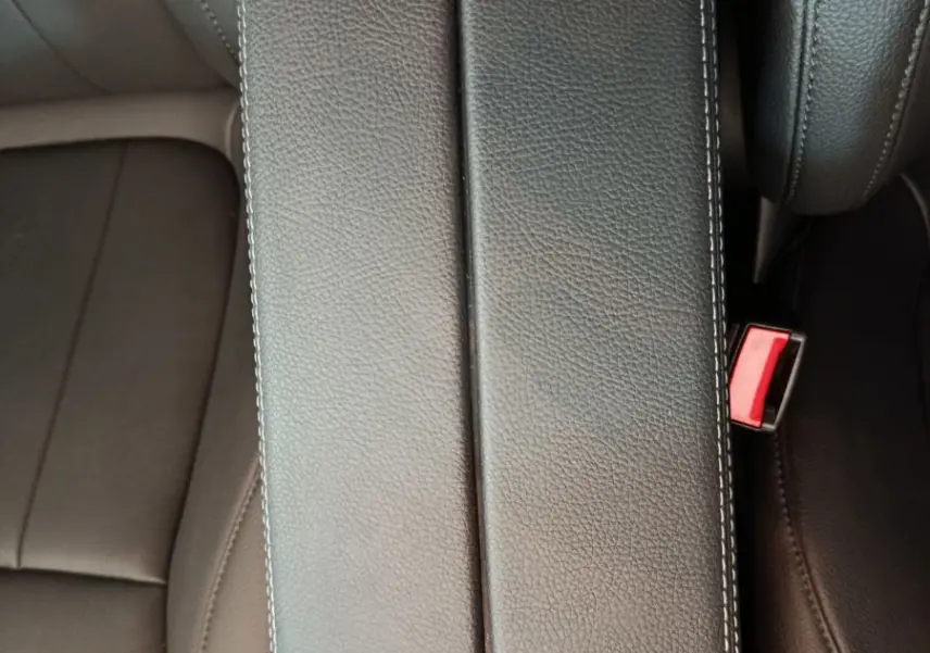 Vue plongeante sur l'accoudoir central en cuir noir et les sièges avant du Mercedes GLA 250 e Business Line 2024.