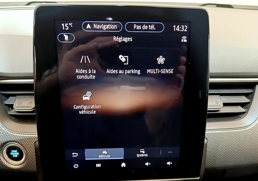Écran tactile central du tableau de bord de la Renault Arkana bleu, affichant les réglages d’aide à la conduite et au parking.