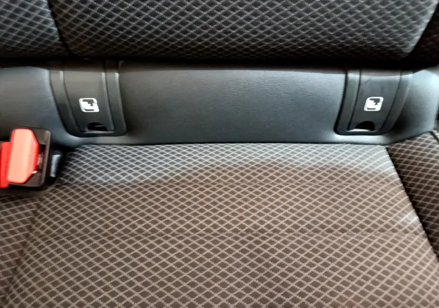 Gros plan sur la banquette arrière grise à motifs avec ancrages Isofix et boucle de ceinture rouge dans une Renault Arkana.